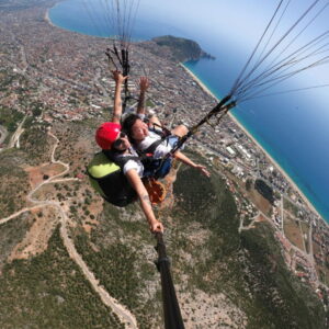 Experience paragliding in Alanya with a scenic flight from the Taurus Mountains and landing at Kleopatra Beach. Hotel pickup included.