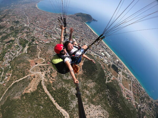 Experience paragliding in Alanya with a scenic flight from the Taurus Mountains and landing at Kleopatra Beach. Hotel pickup included.